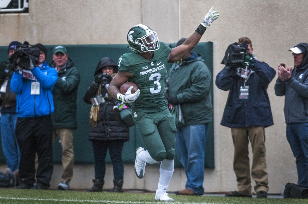 Sophomore running back L.J Scott (3) celebrates after scoring the first touchdown during the first quarter of the game against Ohio State on Nov. 19, 2016 at Spartan Stadium. 