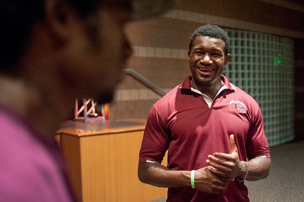 	<p>Former <span class="caps">MSU</span> football player Chris Norman speaks with Detroit resident Zakafata Abduahaqq after addressing a church audience, June 15, 2013, at Oak Pointe Church, 50200 W. 10 Mile Road, in Novi, Mich. Norman decided enter the seminary instead of playing in the <span class="caps">NFL</span> upon graduation. Justin Wan/The State News </p>