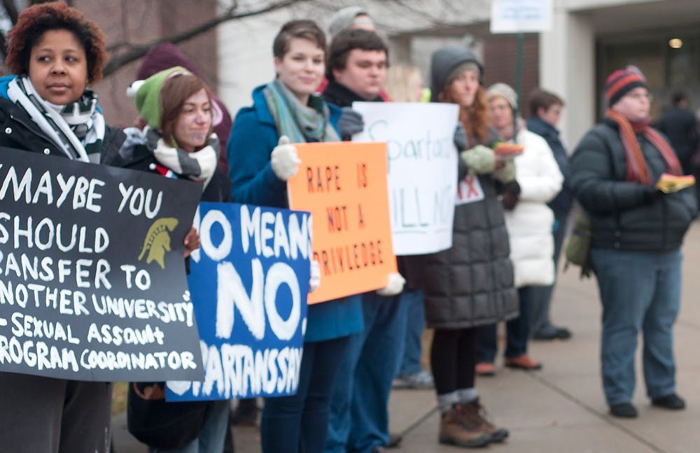 <p>Protesters stand outside of the commencement ceremony Dec. 13, 2014 during a protest against commencement speaker, George Will outside of Breslin Center. This protest was inspired by a column that Will had wrote earlier in the year. Jessalyn Tamez/The State News </p>