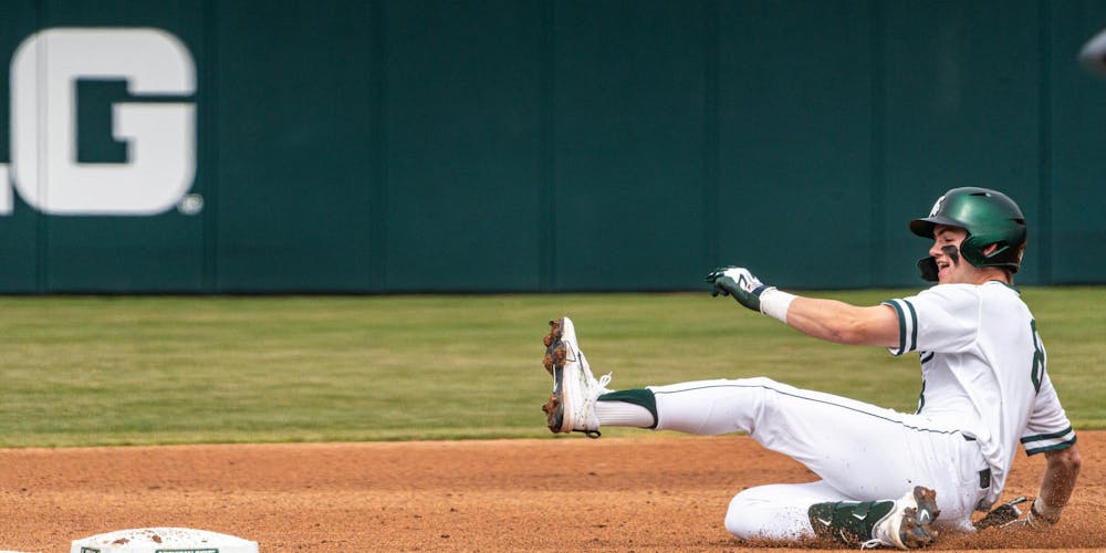 MSU So. OF/LHP, Isaac Sturgess (8), slides to third base in the Jeff Ishbia Field in McLane Stadium in East Lansing, MI on March 21, 2026.