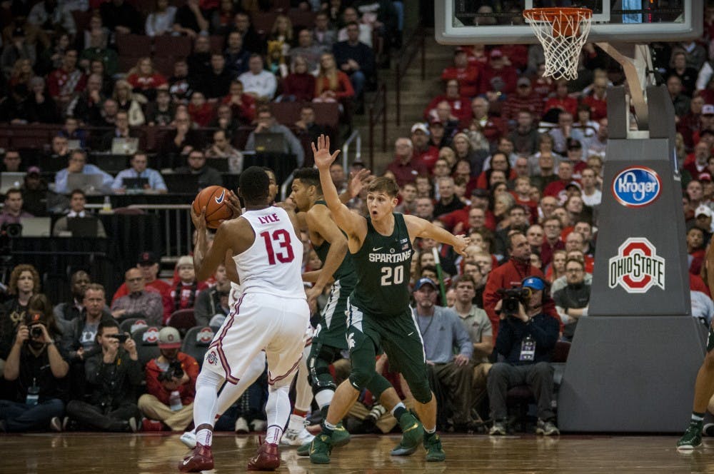 Ohio State guard JaQuan Lyle (15) looks to shoot as sophomore guard Matt McQuaid (20) plays defence during the game against Ohio State on Jan. 15, 2017 at the Jerome Schottenstein Center. The Spartans were defeated by the Buckeyes, 67-72.