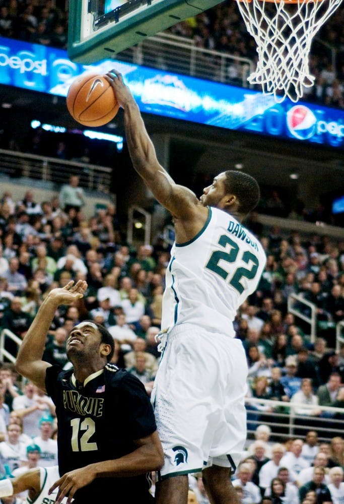 Freshman guard Branden Dawson bats down the ball shot to the basket by Boilermaker guard Kelsey Barlow. The Spartans defeated the Boilermakers 83-58 Saturday afternoon at Breslin Center. Anthony Thibodeau/The State News