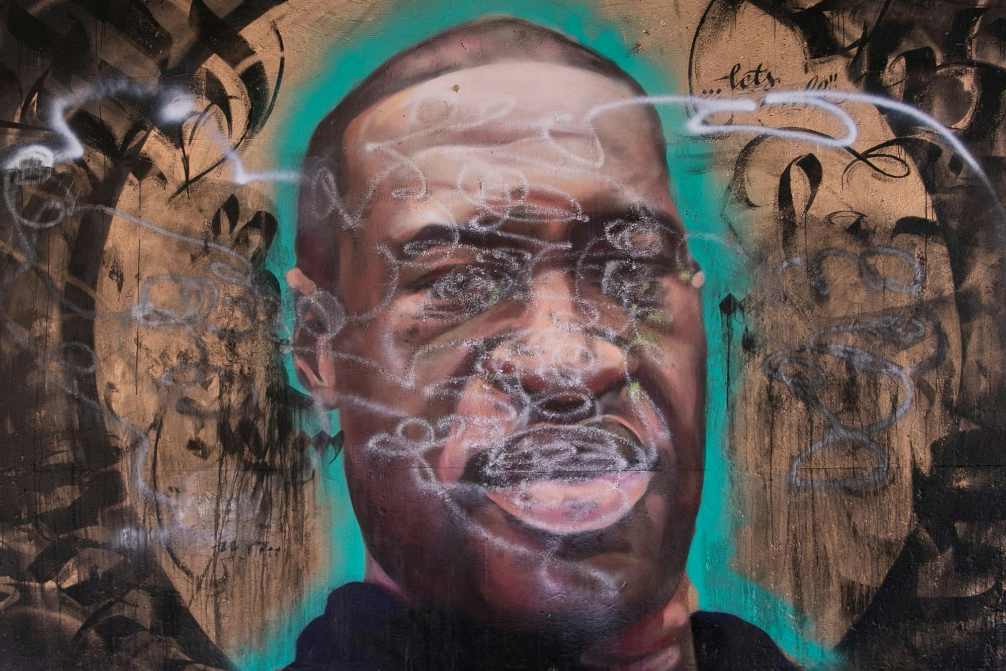 <p>A mural of George Floyd painted after his death at the hands of Minneapolis police that was later defaced is pictured on Lansing River Trail on July 8, 2020.</p>