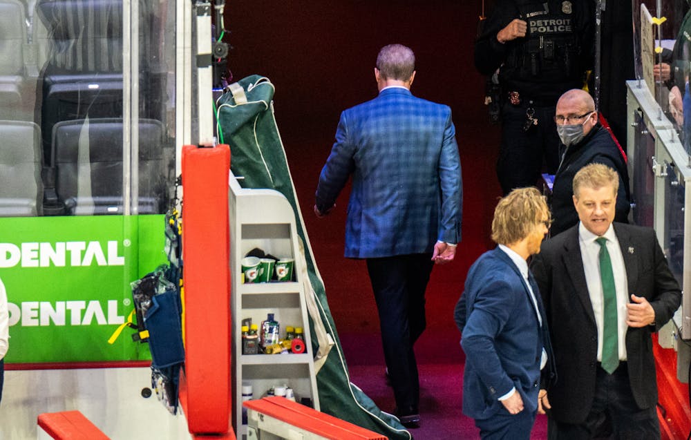 <p>Former Head Coach Danton Cole walks alone back to the locker room after Michigan State fell to Michigan. The Spartans battled the Wolverines and lost 7-3 at the Duel of the D event at Little Caesars Arena in Detroit on Feb. 12, 2022. </p>