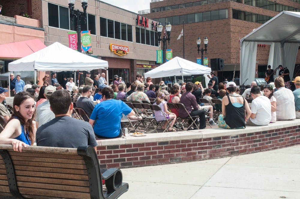 <p>Festival goers listen to music being performed near the corner of M.A.C and Albert avenues on May 17, 2015 at the East Lansing Art Festival. Asha Johnson/The State News</p>