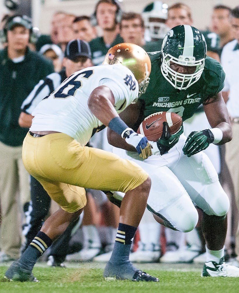 	<p>Redshirt freshman defensive end Lawrence Thomas carries the ball as Notre Dame’s safety Jamoris Slaughter goes after him on Sept. 15 at Spartan Stadium. </p>