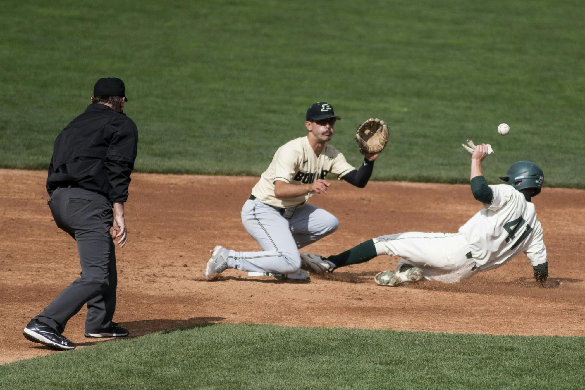 <p>Freshman infielder Mitch Jebb (41) slides into second base as the ball comes his way during the game against Purdue on April 11, 2021, at McLane Stadium. The Spartans defeated the Boilermakers, 5-2.</p>
