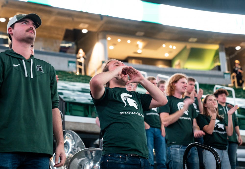 <p>A Spartan marching band member cheers on the MSU women's basketball team against Oakland at the Breslin Center on Nov. 15, 2022. The Spartans defeated the Grizzlies 85-39.&nbsp;</p>