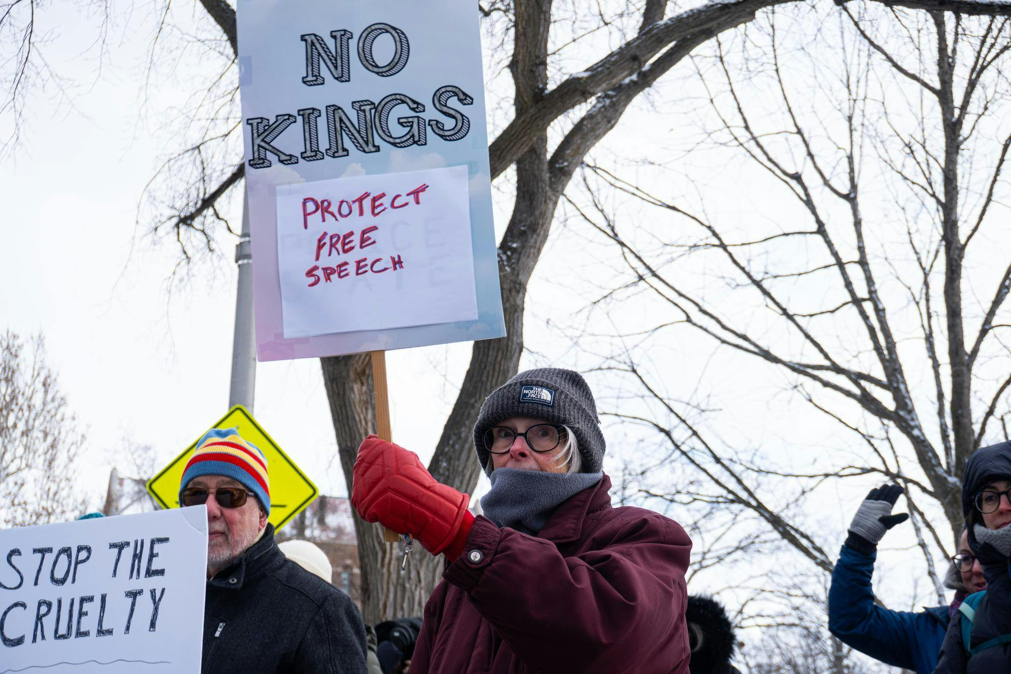 A woman holds a sign while participating in a protest outside the Michigan State University Main Library along West Circle Drive in East Lansing, Michigan on Tuesday, Jan. 20, 2026.