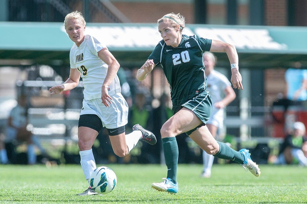 	<p>Senior forward Olivia Stander runs down the field with the ball with Iowa defender Alex Melin next to her. The Spartans tied with the Hawkeyes, 0-0, on Sunday, Sept. 30, 2012 at DeMartin Stadium. Justin Wan/The State News</p>