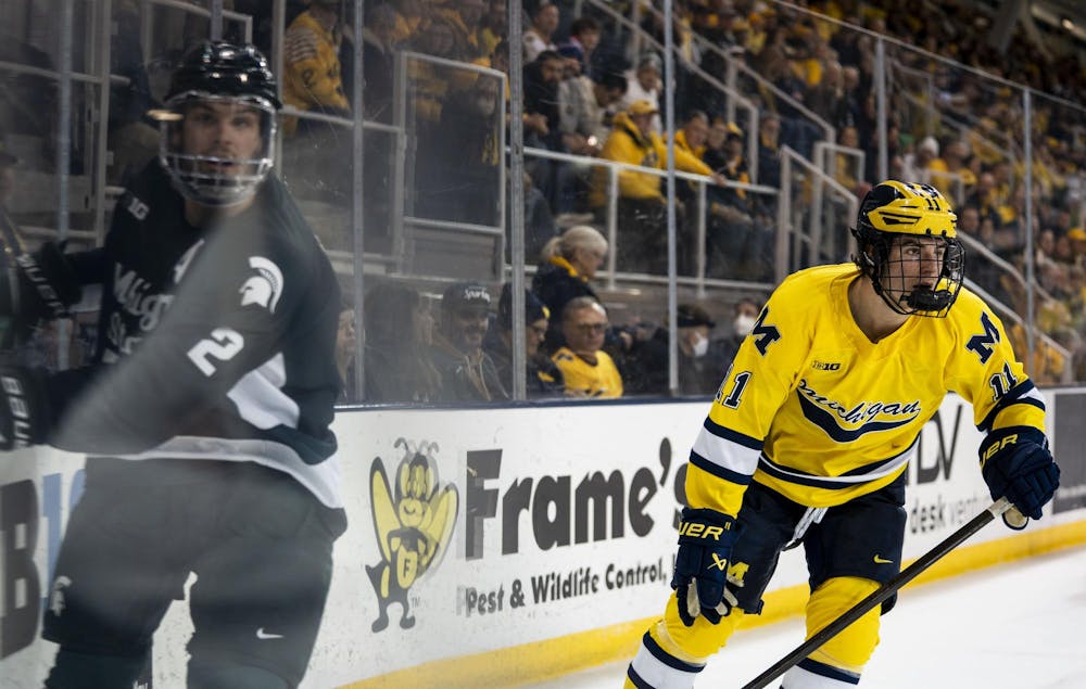 <p>Michigan State junior defense Patrick Geary (2) and University of Michigan freshman forward (11) skate after the puck at the Yost Ice Arena in Ann Arbor, Mich. on Dec. 6, 2025.</p>