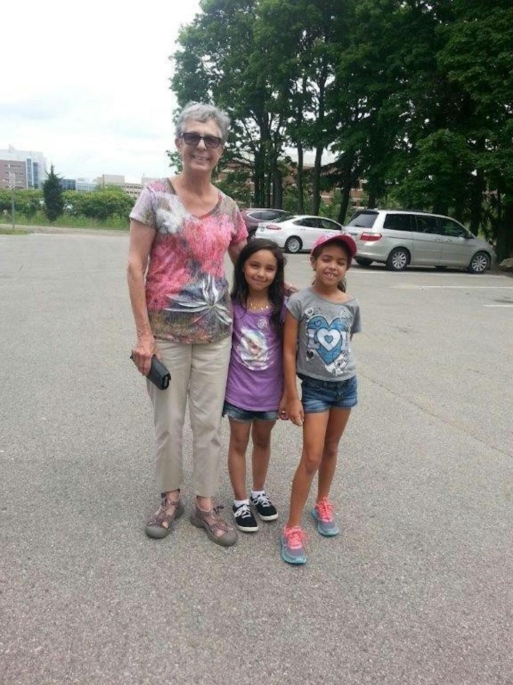 <p>74-year-old Williamston resident Jane Johnson poses for a photo with 8-year-old girls HallieJo Battisfore and Giselle Schneider after the two recovered her wallet on Monday, June 15 at the Clarence E. Lewis Landscape Arboretum. (Photo courtesy MSU Police)</p>