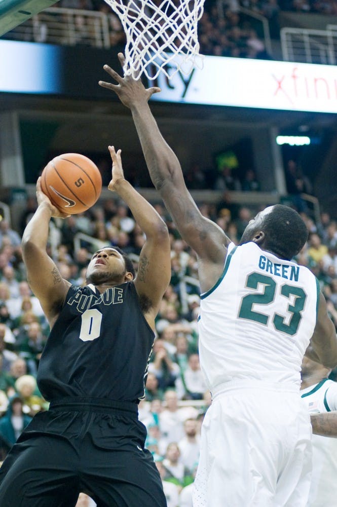 Purdue guard Terone Johnson attempts to get a basket with senior forward Draymond Green reaching to stop the play. The Spartans defeated the Purdue Boilermakers, 83-58, Saturday afternoon at Breslin center. Justin Wan/The State News