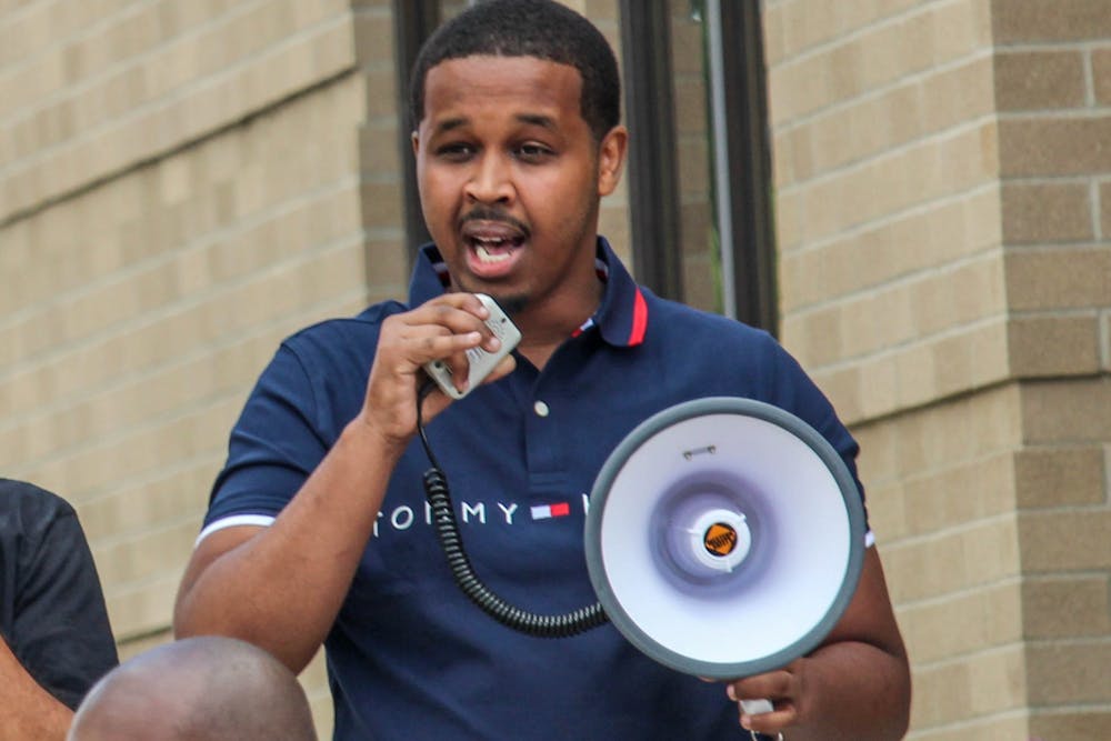 <p>Farhan Sheikh-Omar gives a speech outside ELPD for the March Against Fear on June 24, 2020.</p>
