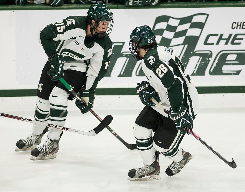 	<p>Freshmen forwards Mackenzie MacEachern, 15, and Thomas Ebbing, 28, skate down the ice toward the Western Ontario net during the game Oct. 9, 2013, at Munn Ice Arena. The Spartans defeated the Mustangs, 4-1. Danyelle Morrow/The State News</p>