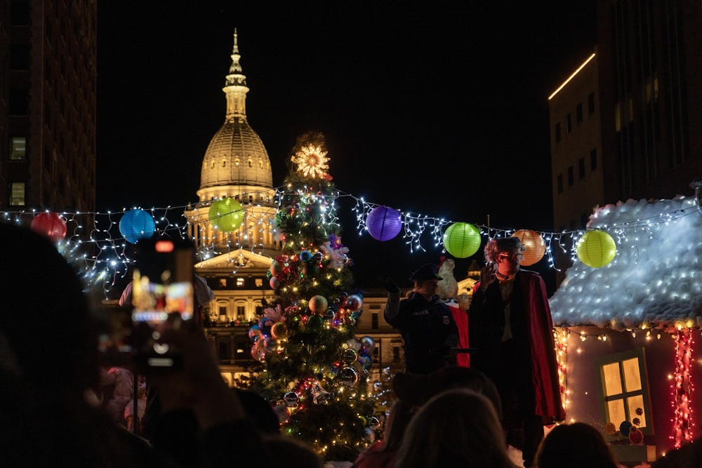 Before the tree lighting, people watched the parade at Lansing Silver Bells in front of the Michigan State Capitol on Nov. 17, 2023. 