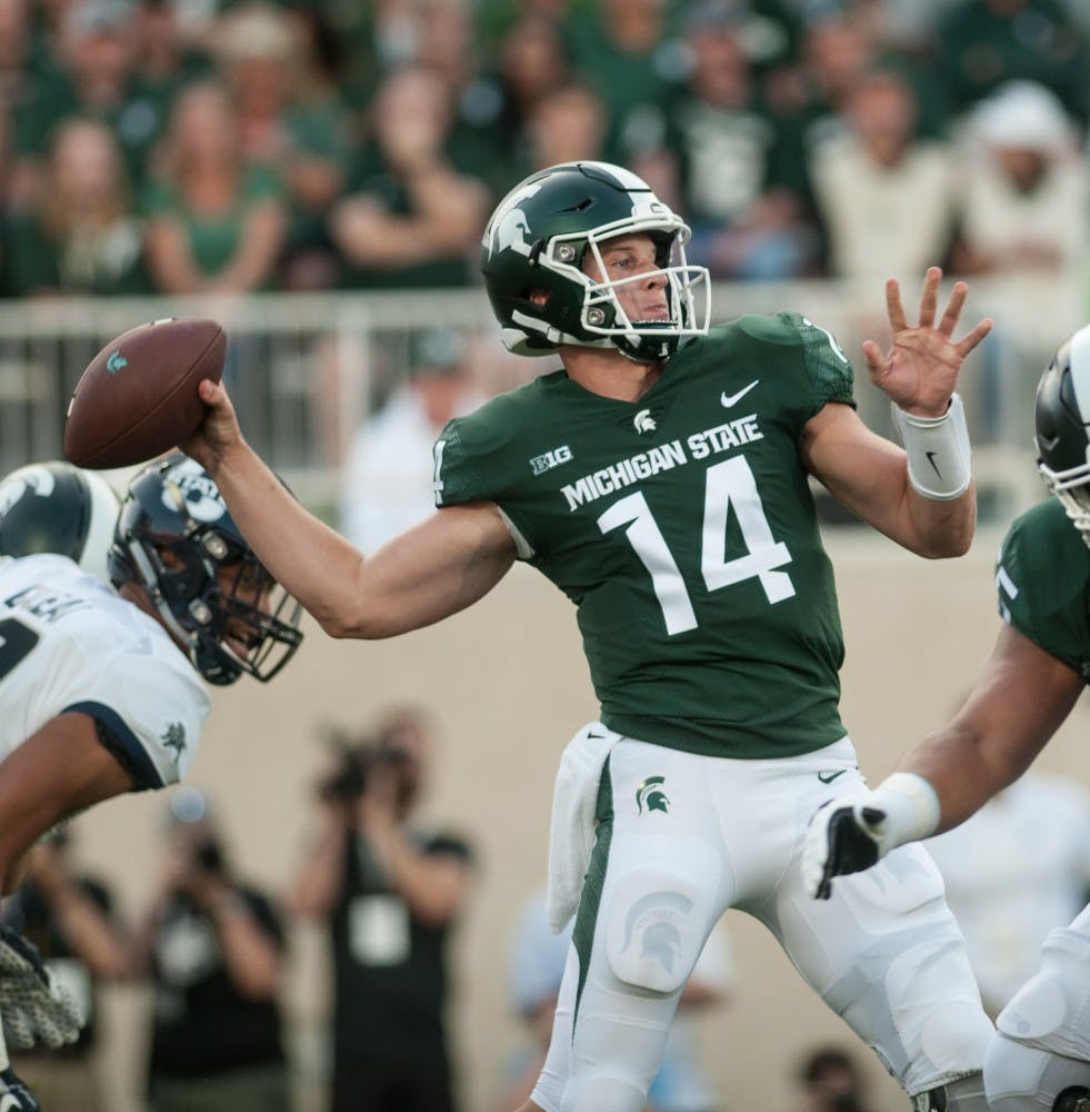 Junior quarterback Brian Lewerke (14) throws the ball during the game against Utah State on Aug. 31, 2018 at Spartan Stadium. The Spartans defeated the Aggies 38-31.
