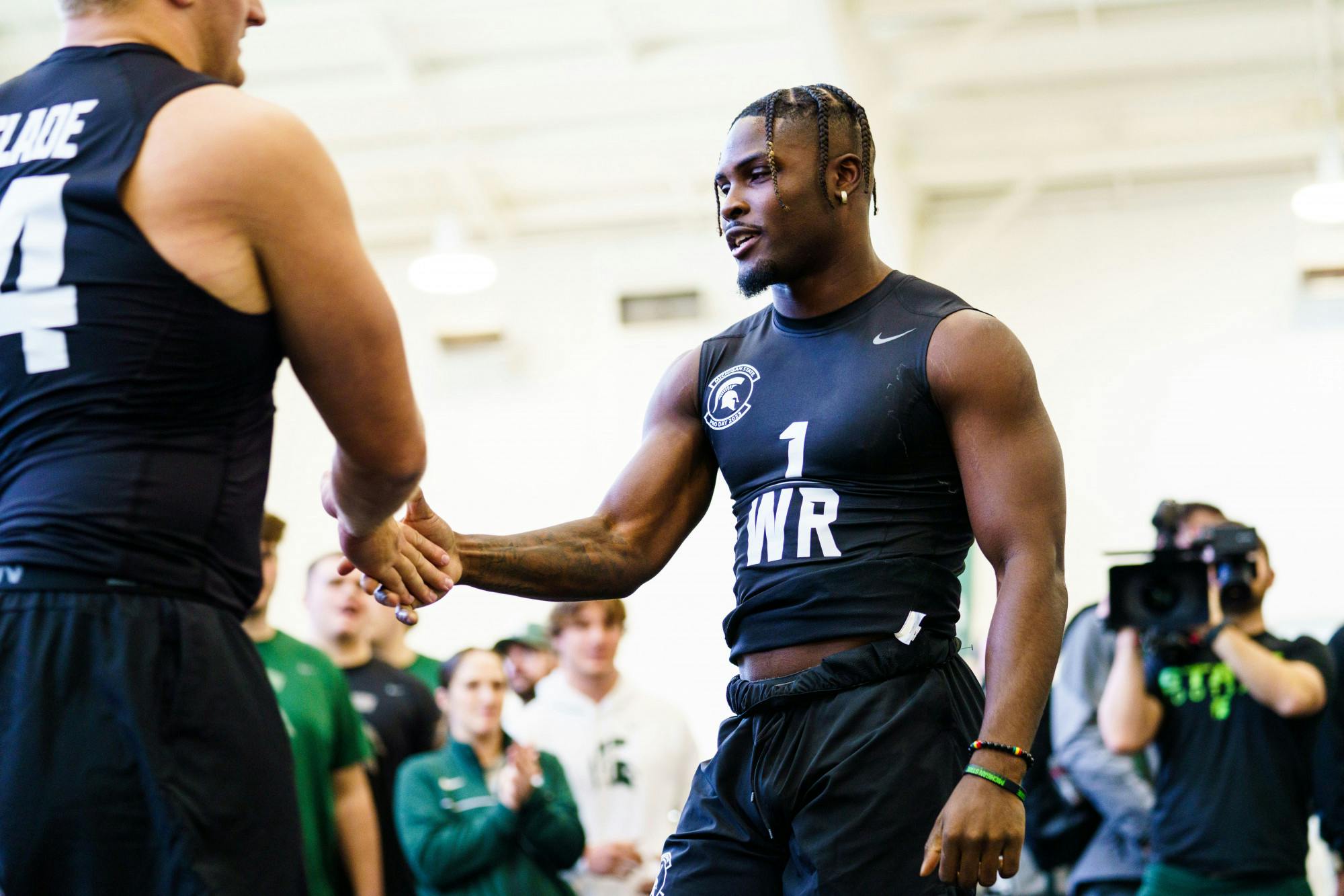 <p>Michigan State wide receiver Jayden Reed high-fives a teammate during MSU Football's pro day, hosted at the Duffey Daughtery Football Building on March 15, 2023.</p>