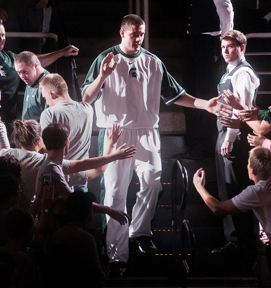 	<p>Freshman forward Kenny Kaminski walks down the aisle as he is introduced to the crowd Friday night, Oct. 12, 2012, during Midnight Madness at the Breslin Center. The event was held to introduce fans to the 2012 Men&#8217;s and Women&#8217;s basketball teams. Adam Toolin/The State News</p>