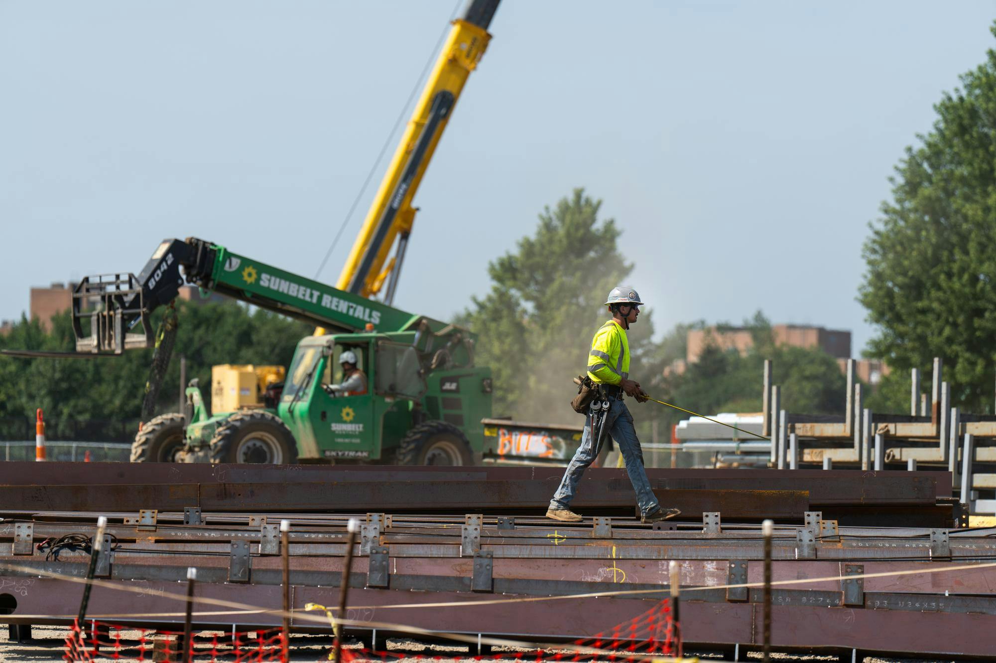 <p>Construction workers continue to work in the heat at the corner of S Shaw Ln and Red Cedar Rd in East Lansing, Mich., on July 14, 2026.</p>