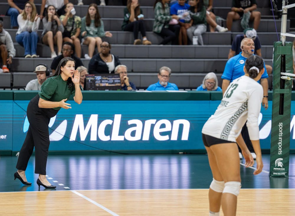<p>Michigan State 2nd Year Head Volleyball Coach advises Jr. OH Aliya Moore during their game against Rutgers on Oct. 1, 2023, at the Jack Breslin Student Events Center.</p>