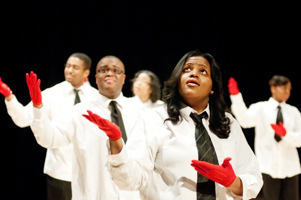 Finance senior Destinee Sadler, center, a member of Signs of Adoration, performs a sign language piece. The group is part of the MSU Gospel Choir, and held the first sign language concert on campus and East Lansing on Saturday night in Synder-Phillips Hall. Josh Radtke