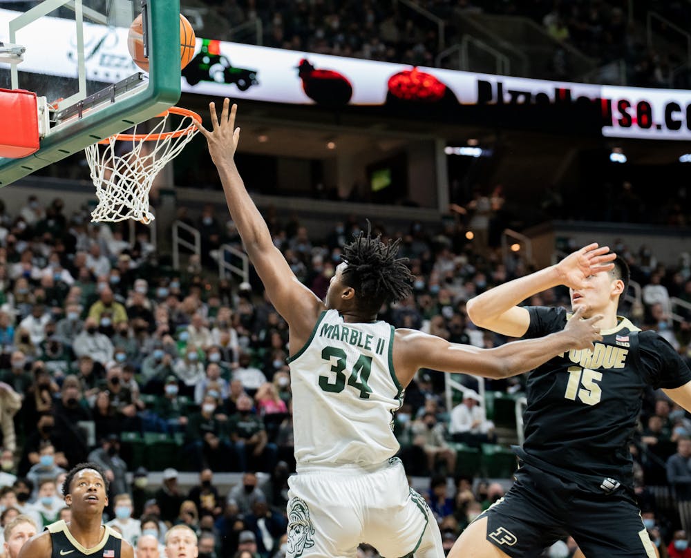 <p>Junior forward Julius Marble (34) finds his way past sophomore center Zach Edey (15) during the Spartans&#x27; upset over No. 4 Purdue on Feb. 26, 2022. Marble made all five of his shot attempts during the game, a key in the Spartans&#x27; victory.</p>