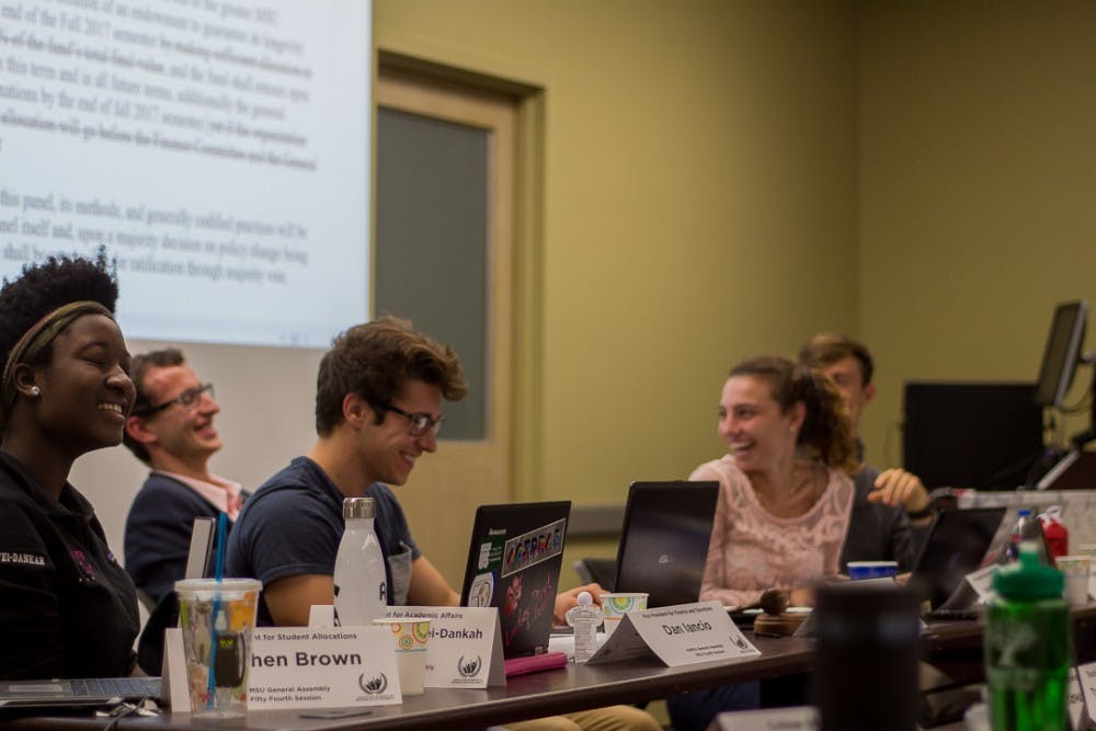 <p>&nbsp;Vice President for Academic Affairs senior Ewurama Appiagyei-Dankah (Left), &nbsp;Vice President for Finance and Operations Dan Iancio, President of ASMSU Lorenzo Santavicca, &nbsp;Katherine Rifiotis Vice President for Internal Administration &nbsp;Katherine Rifiotis, and Vice President of Governmental Affairs &nbsp;Tyler VanHuyse laugh during an ASMSU meeting on Oct. 5, 2017 at Student Services. The meeting concluded by passing Bill 54-06 which aims to support sexual assault victims in the MSU community by a vote of 39-2-0.&nbsp;</p>
