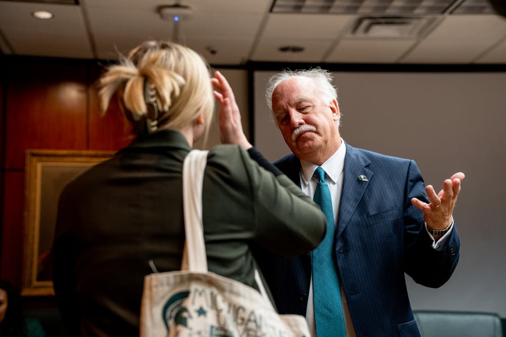 ASMSU President Jo Kovach speaks to Michigan State University Trustee Pat O'Keefe after the Board of Trustees meeting on Oct. 28, 2022.