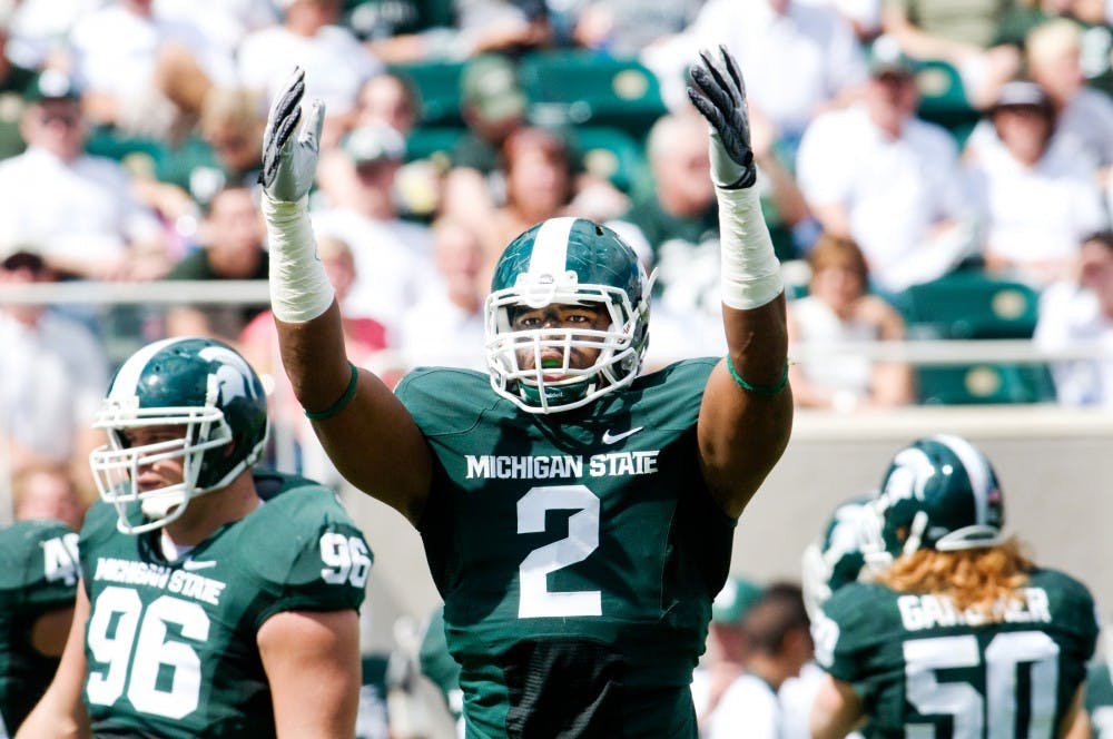 Sophomore defensive end William Gholston throws his arms in the air to excite the crowd after junior defensive tackle Jerel Worthy sacked Flordia Atlantic quarterback David Kooi Saturday night at Spartan Stadium. The Spartan defense stayed solid throughout Saturday's game, holding the FAU Owls to 48 offensive yards. Matt Hallowell/The State News