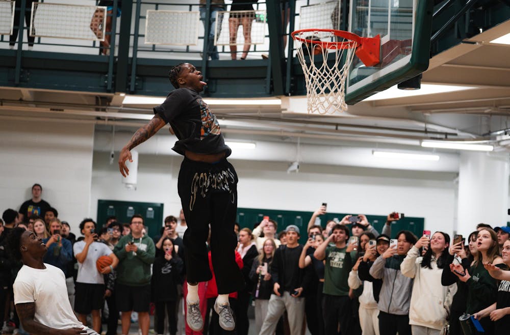 Michigan State sophomore forward Coen Carr dunks the ball in front of students at IM East on April 16, 2025. The men's basketball team showed off their skills during pickup runs for students to enjoy.