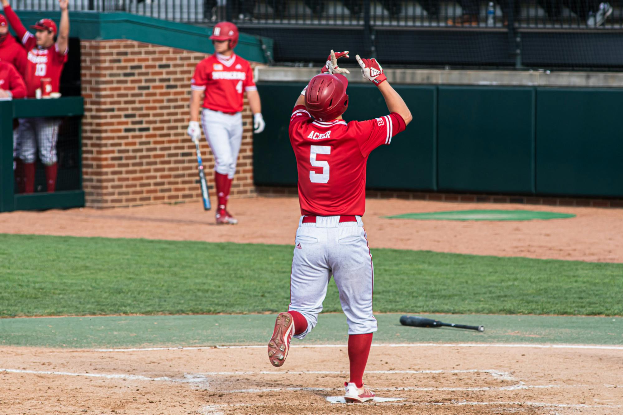 Senior outfielder Joe Acker celebrates as he crosses home plate on April 23, 2021. Nebraska beat the Spartans 4-0.