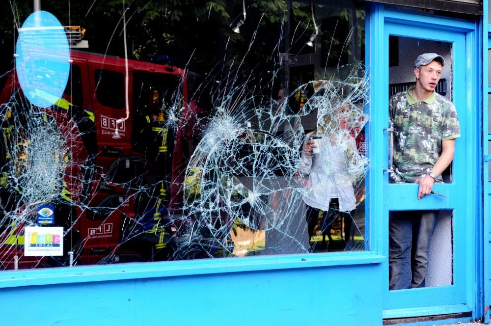 	<p>Shopkeepers begin to clean up on Ealing High Street following a night of civil unrest on the streets of London, on August 9, 2011. Disturbances broke out late on Saturday night in Tottenham and the surrounding area after the killing of Mark Duggan, 29, and a father-of-four, by armed police in an attempted arrest on August 4. Prime Minister David Cameron returned home from his summer holiday in Tuscany, Italy to respond to the rioting. </p>