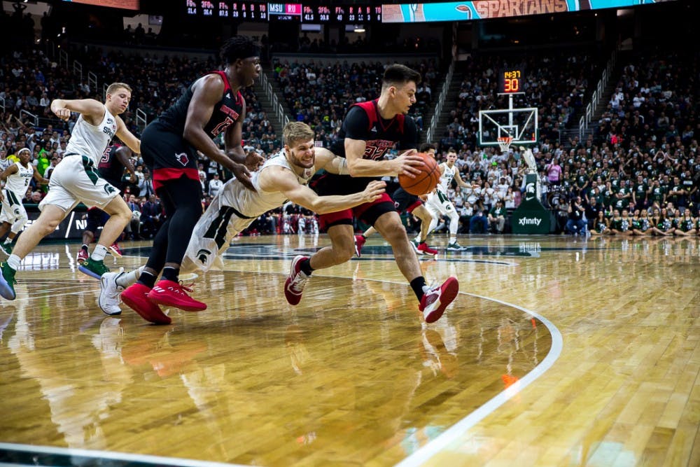 Redshirt junior guard Kyle Ahrens (0) lunges after the ball during the game against Rutgers on Feb. 20, 2019 a the Breslin Center. The Spartans beat the Scarlet Knights, 71-60.