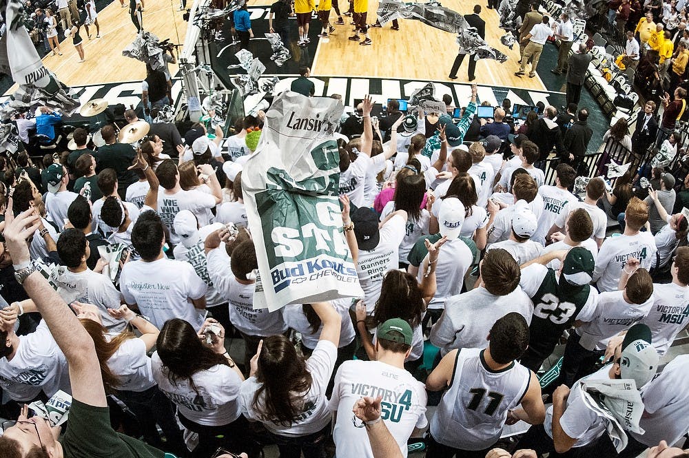 	<p>Members of the Izzone throw their newspapers in the air after the Minnesota team is introduced Wednesday, Feb. 6, 2013, at Breslin Center. The Spartans defeated the Golden Gophers, 61-50, improving their record to 8-2 in the Big Ten. Adam Toolin/The State News</p>