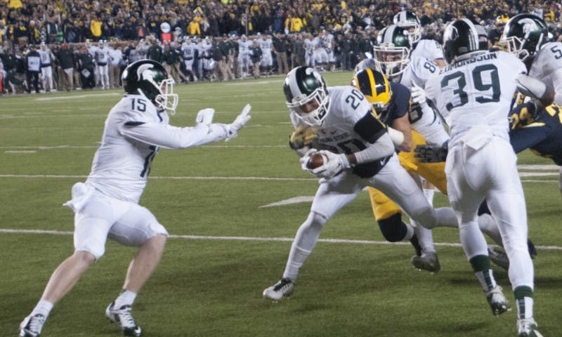 <p>Sophomore defensive back Jalen Watts-Jackson runs the ball for the game winning touchdown during the game against Michigan on Oct. 17, 2015 at Michigan Stadium. The Spartans defeated the Wolverines, 27-23.</p>