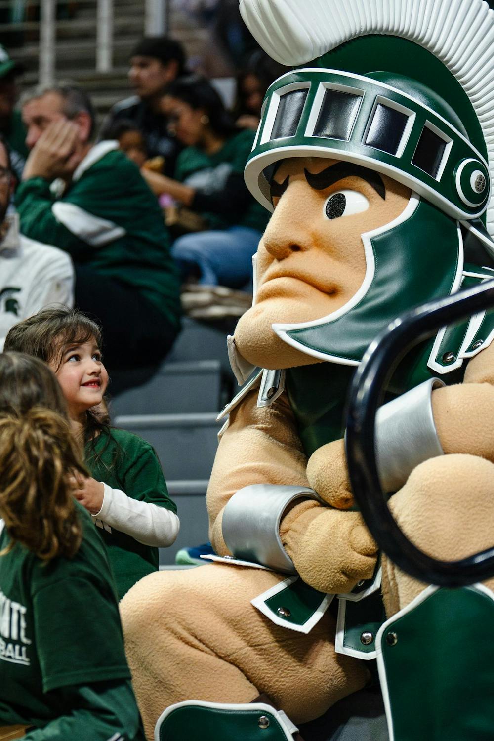 Sparty hangs out with a fellow spartan in the stands at the women’s basketball game against DePaul University at the Breslin Center on Dec. 8, 2024. The Spartans won 89-61 against the Blue Demons, starting the season 9-0 for the first time in program history. 