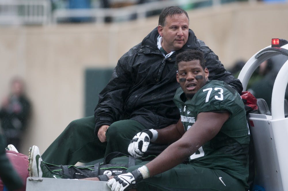 <p>Sophomore offensive lineman Dennis Finley is driven off the field during the Homecoming game against Purdue on Oct. 3, 2015 at Spartan Stadium. He broke his right tibia and fibia during the second quarter. The Spartans defeated the Boilermakers, 24-21.  </p>
