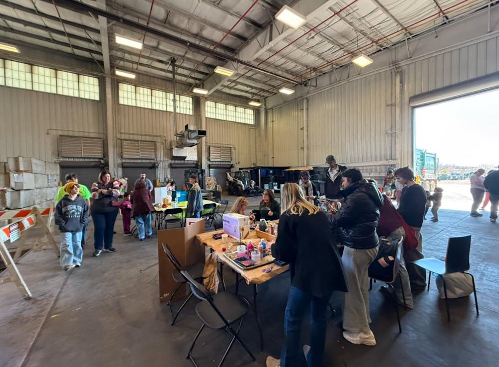 <p>Attendees at look at the various tables and activities at the MSU Earth Bash at the Surplus Store on April 12, 2025.</p>