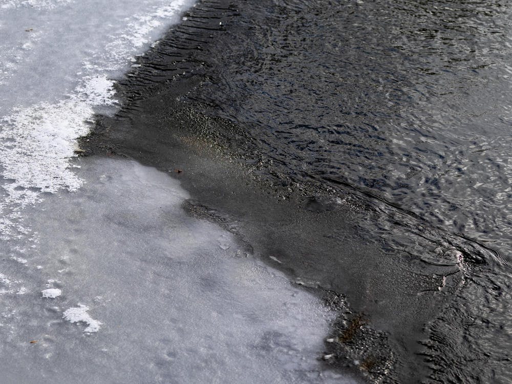 Ice and water meet at the Red Cedar River in East Lansing, Michigan, on Saturday, Feb. 7, 2026. 