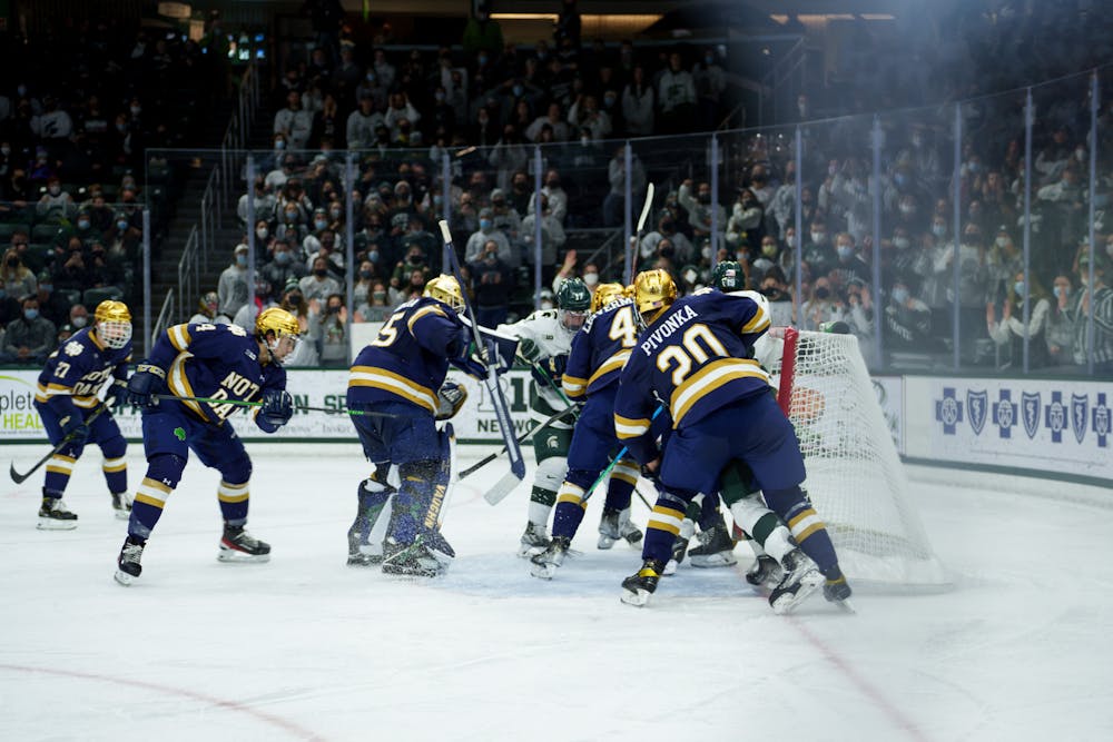 <p>Michigan State sophomore A.J. Hodges and sophomore Kyle Haskins getting smashed into the goal by Notre Dame senior Jake Pivonka and senior Nick Leivermann mainly, even moving the goal on Feb. 18, 2022. Spartans lost 2-1 against Notre Dame</p>