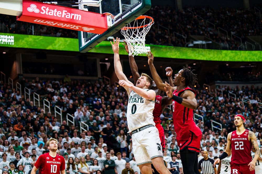<p>Freshman forward Jaxon Kohler (0) finishes at the rim during a matchup against Rutgers, held at the Breslin Center on Jan. 19, 2023. The Spartans defeated the Scarlet Knights 70-57.</p>