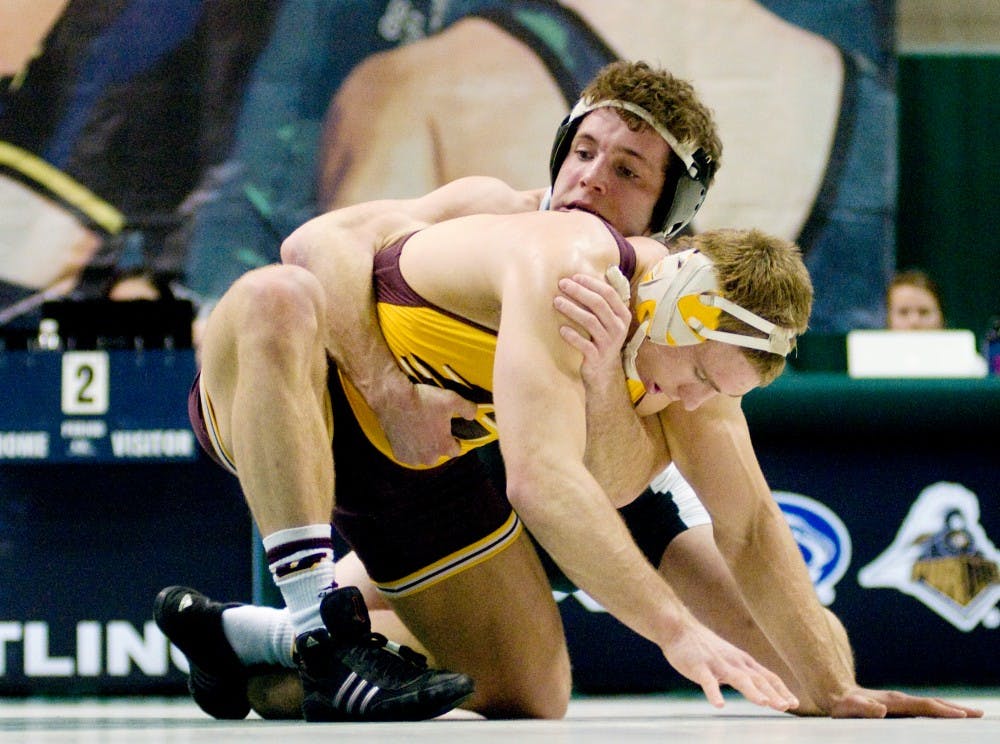 Junior Curran Jacobs struggles to hold on to Central Michigan sophomore Ben Bennett Friday at Jenison Field House.  Jacobs fell to Bennett, 5-2.  Katy Joe DeSantis/The State News