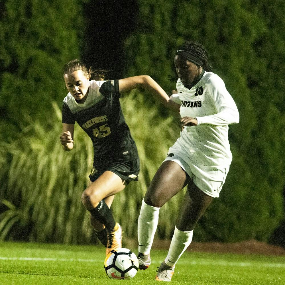 <p>Senior forward Kristelle Yewah (10) dribbles the ball past Wake Forest forward Bri Carney (45) during the game against Wake Forest on Sept. 7, 2017 at DeMartin Stadium at Old College Field. The Spartans fell to the Demon Deacons , 4-1.&nbsp;</p>