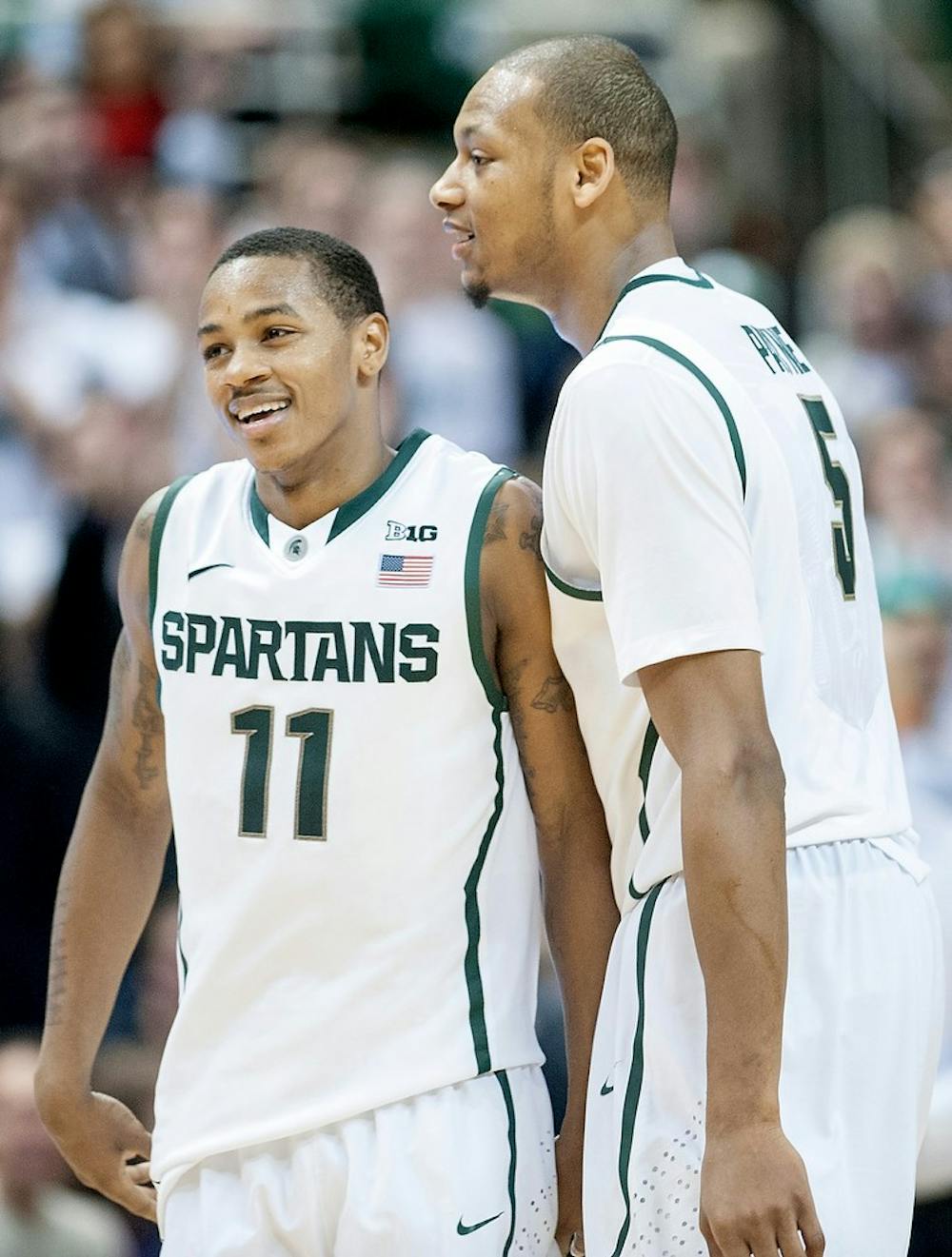 	<p>Junior guard Keith Appling, left, laughs with junior center Adreian Payne at the final minutes of the game. Payne contributed 14 points while Appling scored 8. The Spartans defeated the Cornhuskers, 66-56, Sunday, Jan. 13, 2013, at Breslin Center. Justin Wan/The State News</p>
