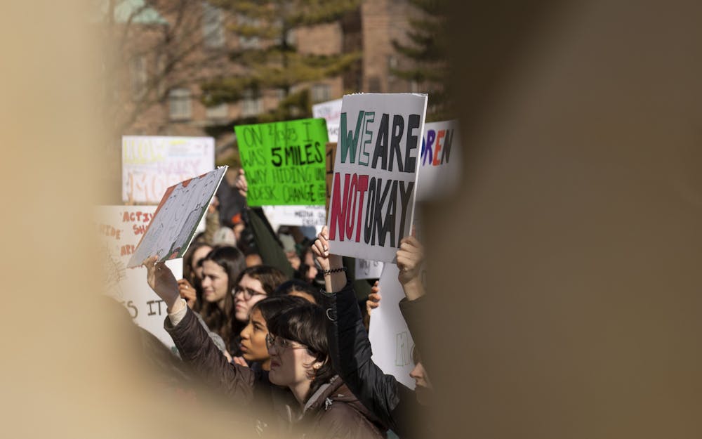Students hold signs protesting the return to classes with a sit-in at the Michigan Capitol Building on Monday, Feb. 20, 2023 - the first day of classes back for Michigan State after the shooting in the university’s north campus seven days earlier. 