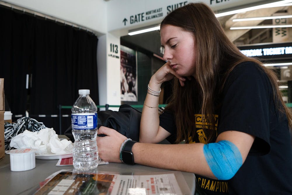 Kineseology junior Peyton Thayer rests after giving blood at the ‘We Give Blood’ drive inside of the Breslin Center on Oct. 30, 2024. 