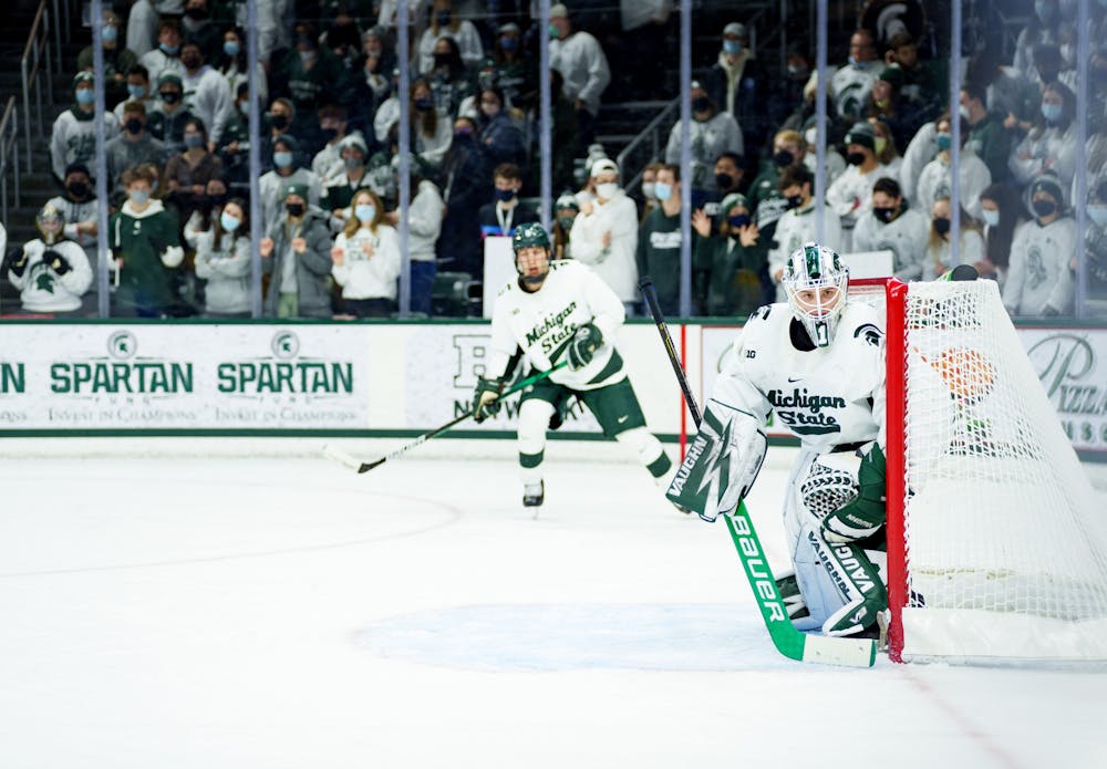 <p>Michigan State senior Drew DeRidder watching the puck intensely with senior Christian Krygier seen behind him on Feb 19, 2022. Spartans lost 4-2 against Notre Dame.</p>