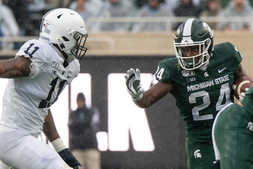<p>Redshirt freshman running back Elijah Collins (24) extends a stiff arm during the game against Penn State Oct. 26, 2019 at Spartan Stadium. The Spartans fell to the Nittany Lions, 28-7.</p>