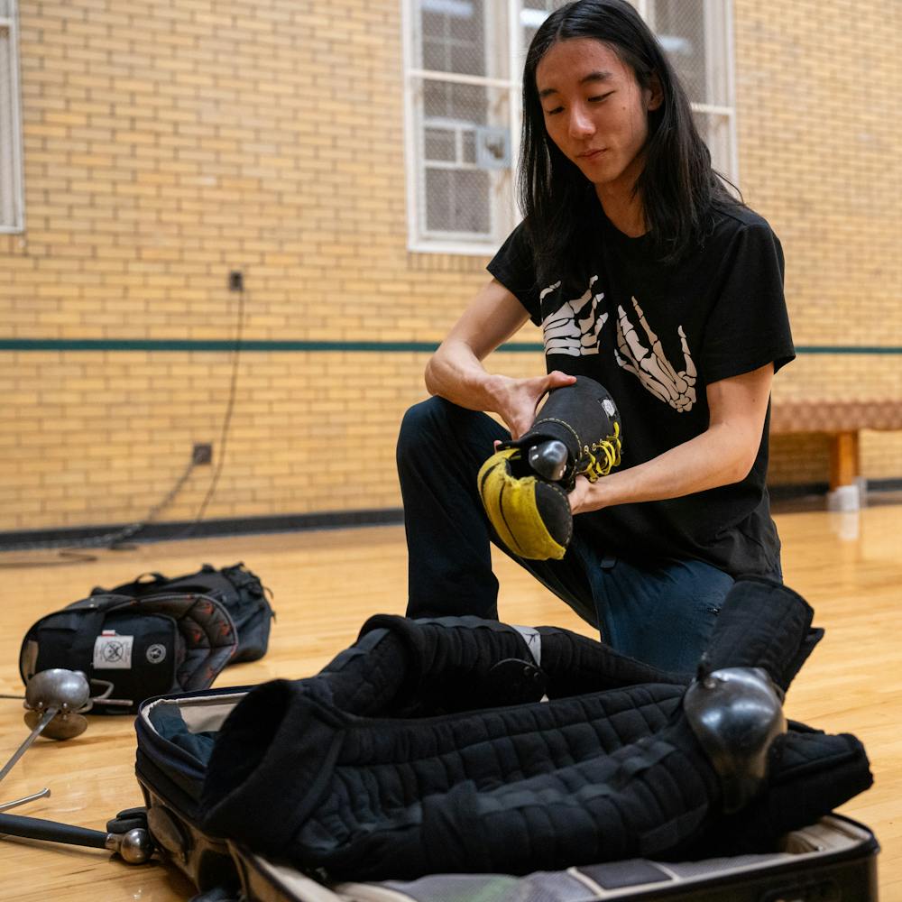 <p>Senior Han Yoo shows off his equipment and gear during a practice session for the MSU Renaissance Sword Society at IM Circle on March 28, 2024.</p>